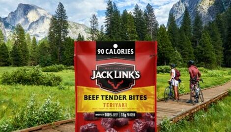 Jack Link's Teriyaki Beef Tender Bites package featured in front of a beautifully green forest trail and mountains.