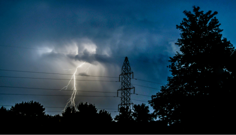 Stormy sky with lighting near power lines.